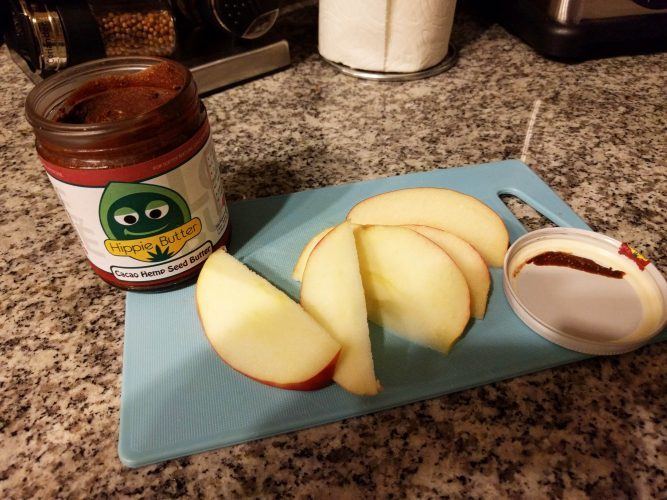 Spreading Cacao Hemp Butter on Apples