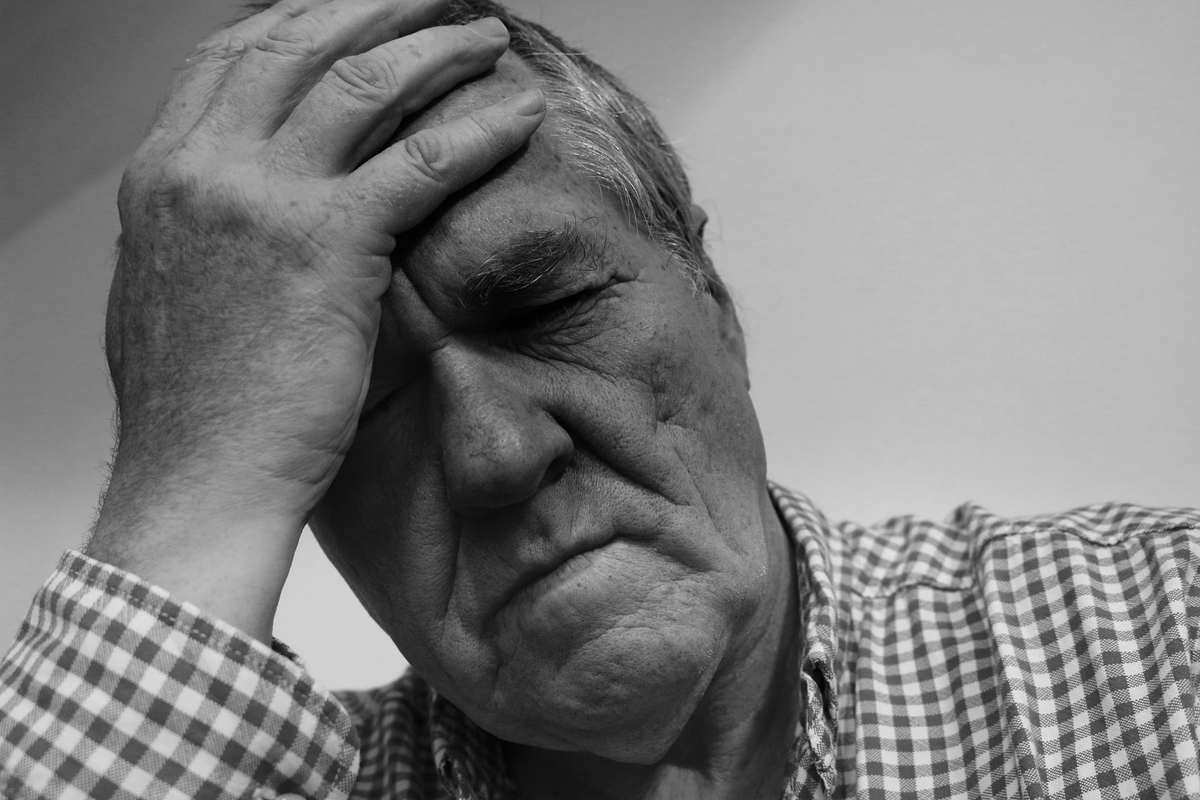 An older man in a plaid shirt clutches his head in anguish. Today, CBD is used to relieve symptoms of numerous conditions, from anxiety and mental illness to chronic pain.
