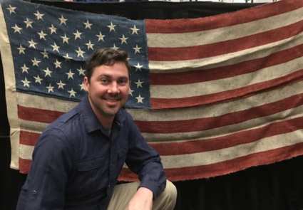 Anavii Market founder Jason Amatucci poses with a U.S. flag hand-sewn from hemp.