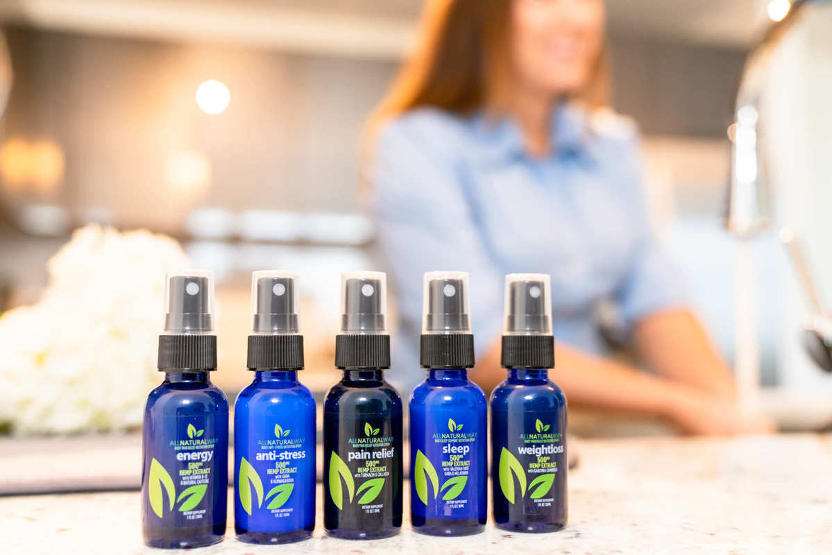 A line-up of All Natural Way CBD products on a kitchen counter. All Natural Way CBD Sleep Spray is part of a full line of specialized sprays.