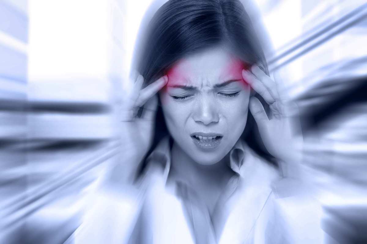 A woman clutches her head in pain, as if suffering from a migraine. Migraine sufferers have been shown to have lower levels of anandamide, a naturally occurring chemical found in all people that's similar to those found in cannabis and hemp.
