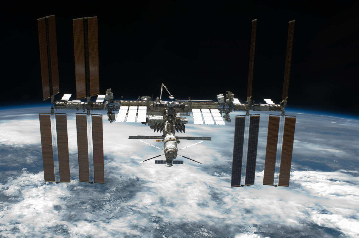 A photo of the International Space Station in orbit over earth, Space Tango and Anavii Market will soon begin experimenting with the immense potential of growing hemp in space.
