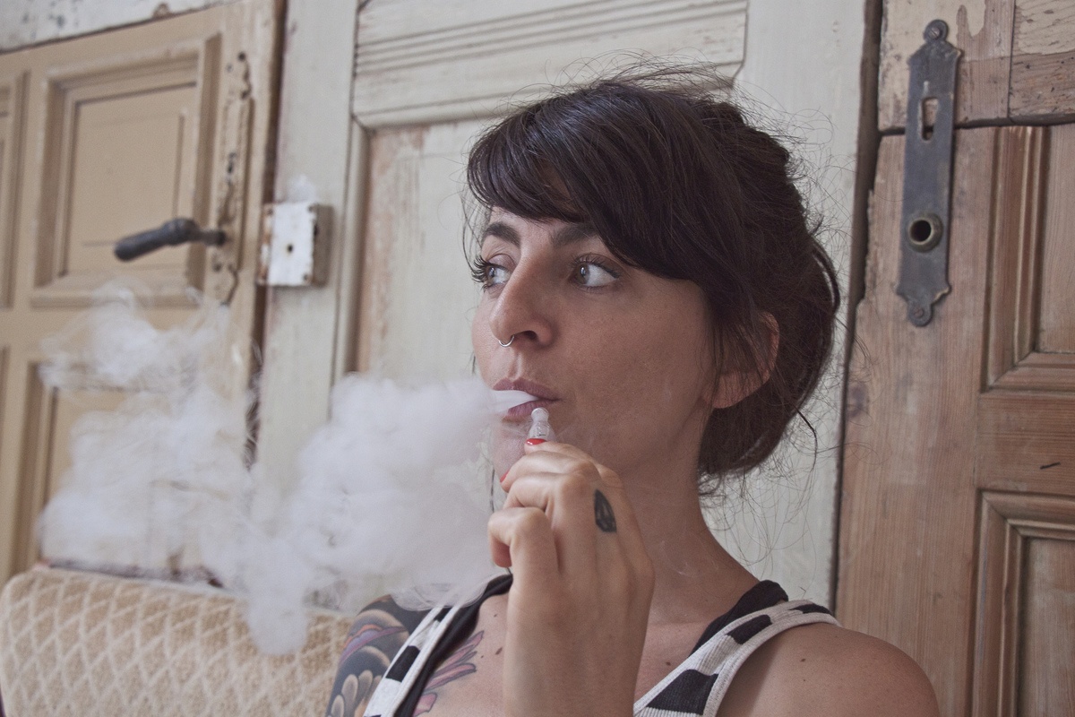 A woman exhales vapor after using a CBD vape. After doing her research CBD, Haddayr Copley-Woods discovered that vaping CBD offered instant and profound relief to symptoms of anxiety caused by Complex PTSD. 