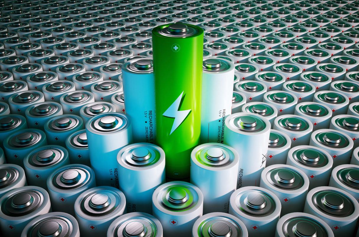 An illustration of a seemingly infinite number of batteries, with a small cluster rising above the others. A green colored battery is higher than the rest.
