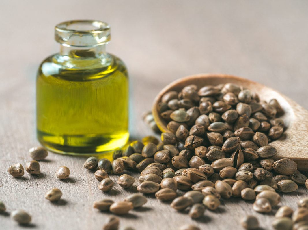 A bottle of hemp oil with an overflowing spoon of hemp seeds. Packed with vitamins and amino acids, hmp oil is a great choice for skincare. Even better, hemp oil wont clog pores.