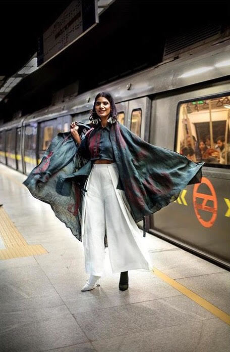 Numerous designers have already incorporated Hemp Fabric Lab into their work. Photo: A female model poses in front of a subway car in India, wearing flowing hemp fabrics.
