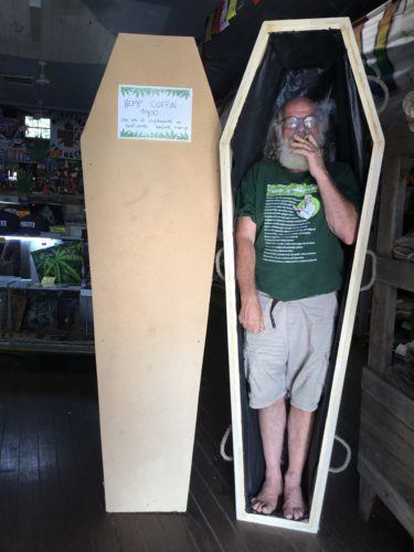 These hemp coffins are handmade at the Hemp Embassy in Nimbin, New South Wales, Australia. Photo: A man smokes a joint while standing in an undecorated hemp coffin, at the Hemp Embassy in Nimbin, New South Wales, Australia.