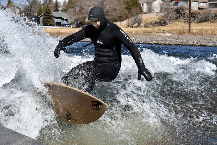 Photo: A surfer in a wetsuit rides a hemp surfboard.