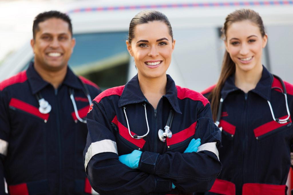 Because of the toll their work takes on their bodies, CBD is ideal for veterans, police, EMTs and other first responders. Photo: A trio of Emergency Medical Technicians in uniform smile, arms crossed.