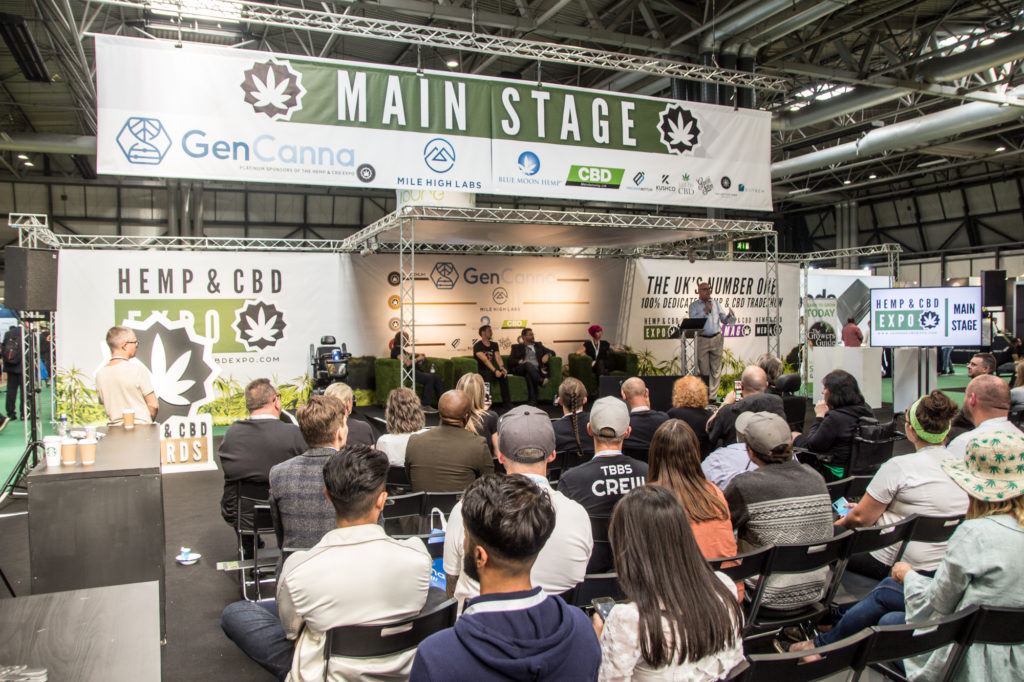 Photo: The main stage at the UK Hemp & CBD Expo, with dozens of people gathered to learn about the future of hemp in the UK.