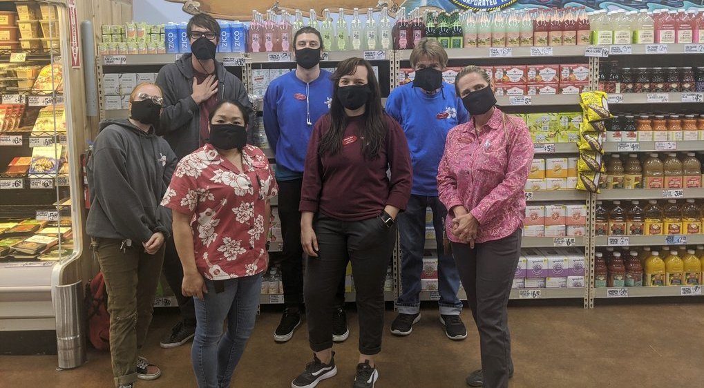 Workers at a Trader Joe's pose in hemp masks created by iLoveBad and The Hemp Cooperative.