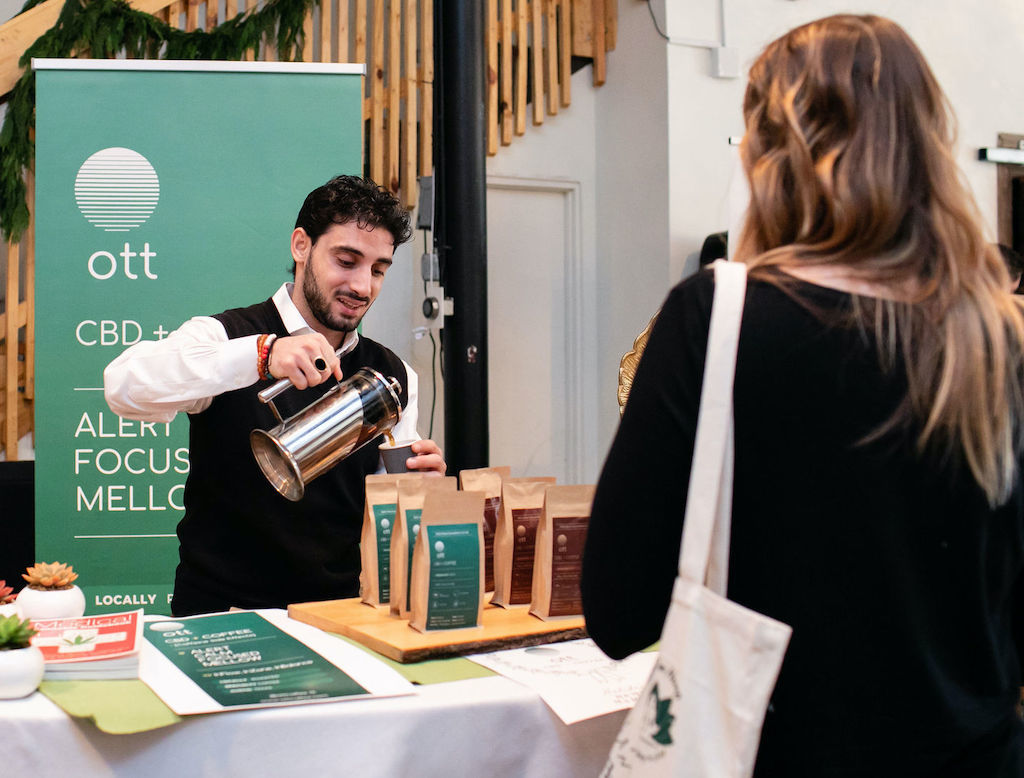 Our podcast guest, Alwan Mortada, pours a sample of his CBD coffee at a holiday market.