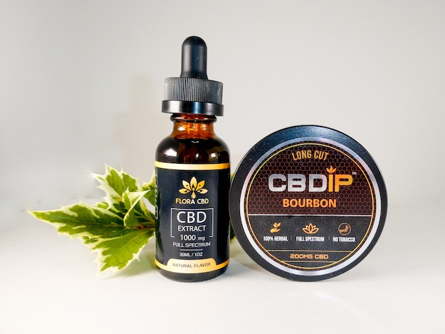 Flora CBD oil and CBD Dip posed with a sprig of ivy.