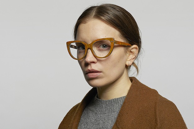 A woman in "turmeric" colored cats-eye style glasses made from hemp, by Hemp Eyewear Edinburgh.