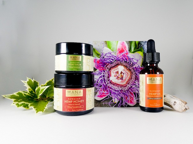 Mana Artisan Botanics Trio, including hemp oil, balm and honey, with a decorative card showing a passionflower and a sprig of ivy.