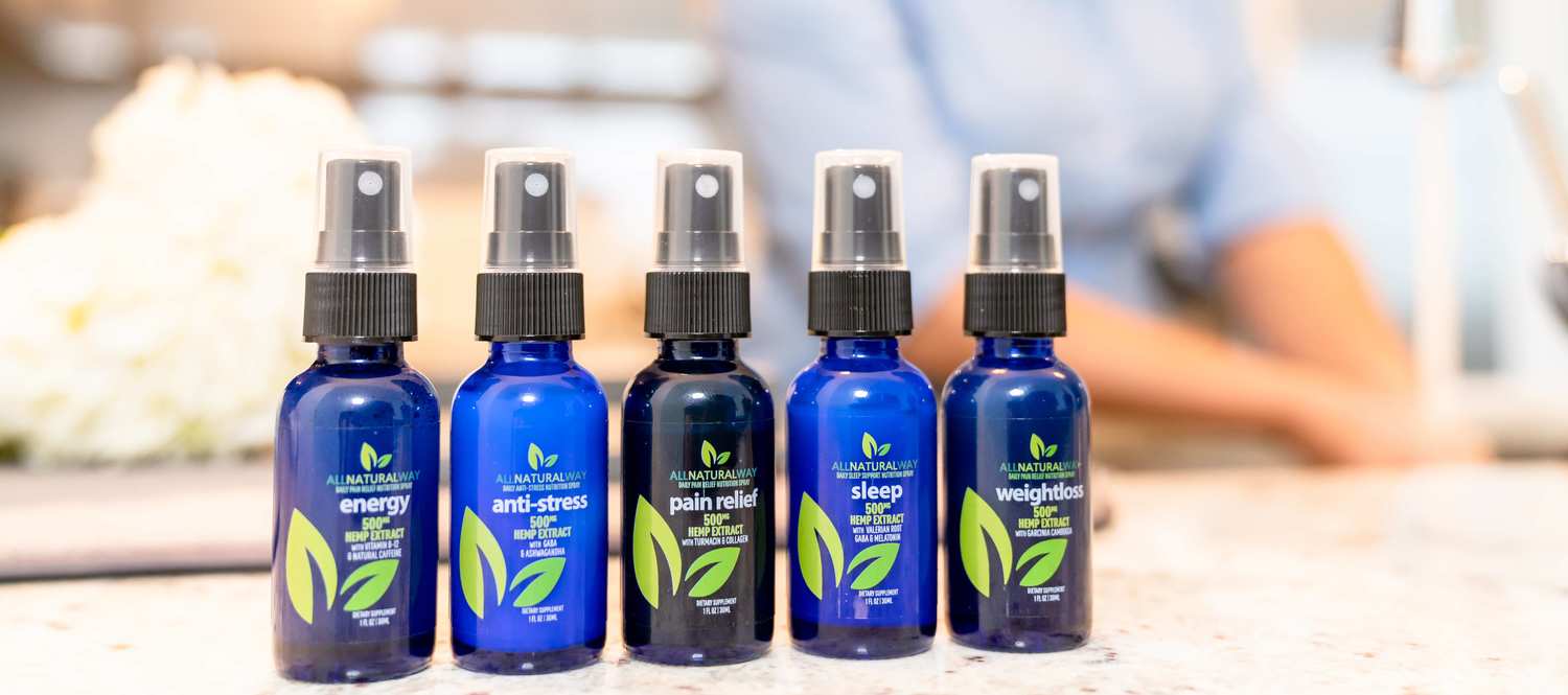 All Natural Way CBD products lined up on a kitchen counter. All Natural Way Sleep Spray is part of a full line of specialized CBD sprays.