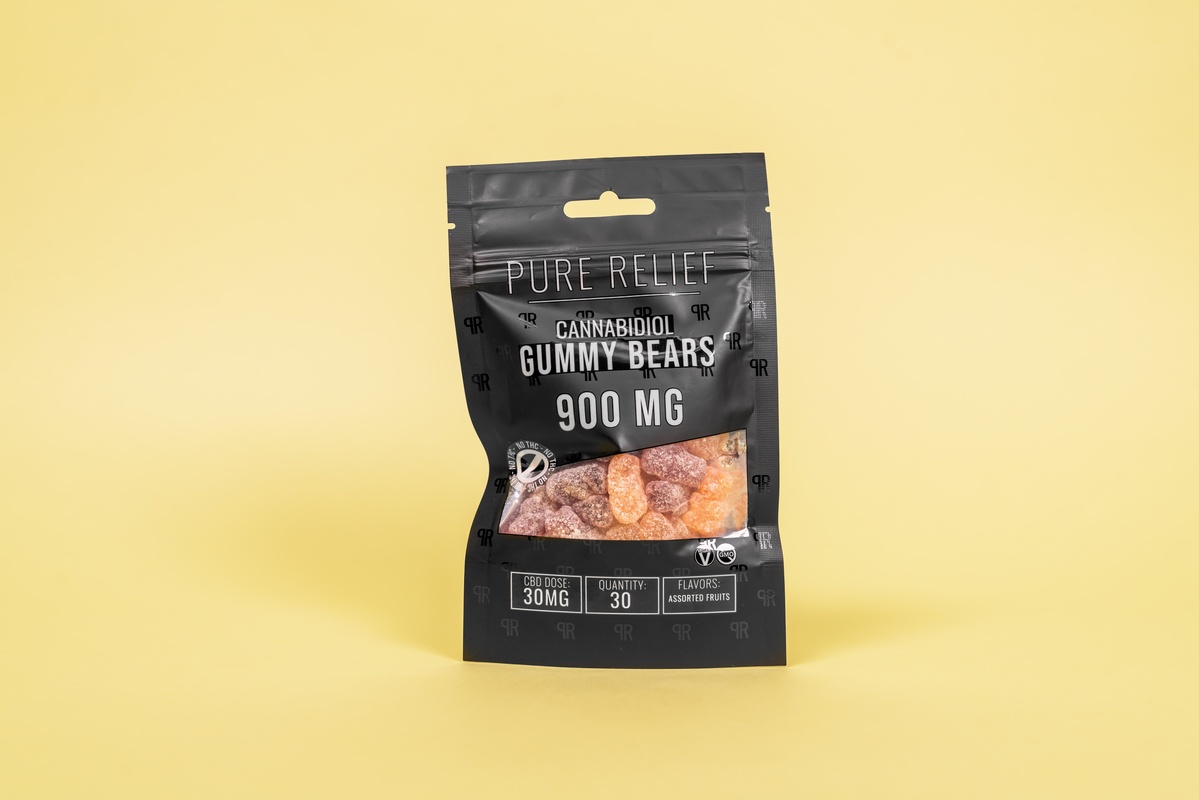 A bag of Pure Relief Pure Hemp Bears CBD Gummies against a solid yellow background.