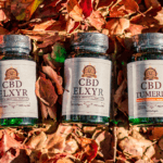 Elxyr CBD Softgels in two strengths, both with and without turmeric. The bottles are posed against a natural, leafy background.