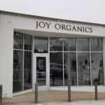 The exterior of Joy Organics Austin store under a overcast sky. In our first "Spotlight" video, we visited the Joy Organics store in Austin, Texas to learn more about buying the right CBD.