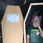A man smokes a joint while standing in an undecorated hemp coffin, at the Hemp Embassy in Nimbin, New South Wales, Australia.