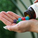 Photo: A person pours Neurogan CBD Gummy Squares from the bottle into the palm of their hand.