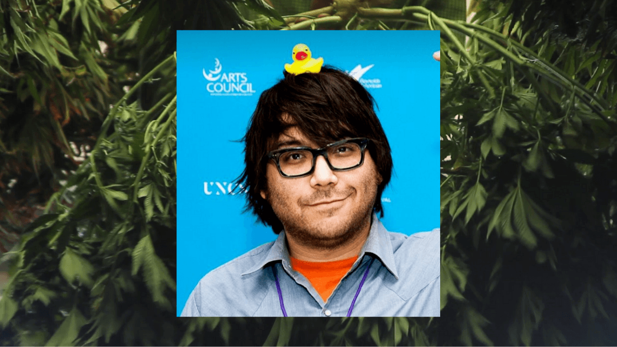 Photo: A composite image of hemp documentary creator Josh Harney, a smiling man with brown hair, a light beard and big dark glasses, with a rubber duck on his head. In the background, a photo of a freshly harvested hemp plant..