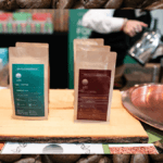 Photo: A composite image of our podcast guest, Alwan Mortada, pouring his Ott CBD coffee at the hemp holiday market, against a backdrop of a photo of coffee beans.